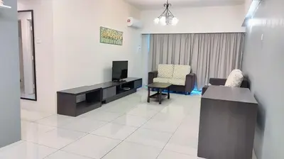 a living room with a tv and a couch and chairs at Kinta Olive in Ipoh
