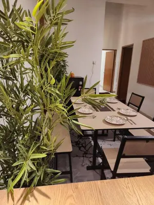 a conference room with a table with plants at Sun Pista Home by Ipoh Maju Stay in Ipoh