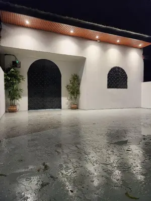an empty room with two potted plants in front of a building at Sun Pista Home by Ipoh Maju Stay in Ipoh