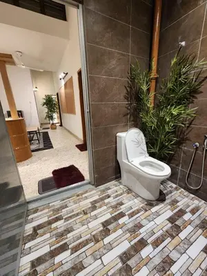 a bathroom with a toilet sitting in a room at Sun Pista Home by Ipoh Maju Stay in Ipoh