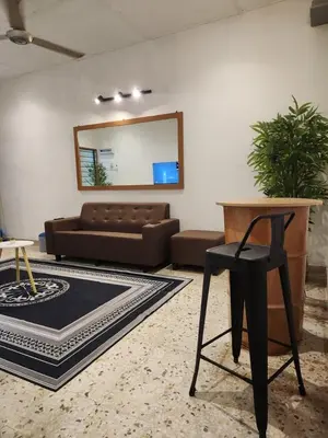 a living room with a couch and a chair at Sun Pista Home by Ipoh Maju Stay in Ipoh
