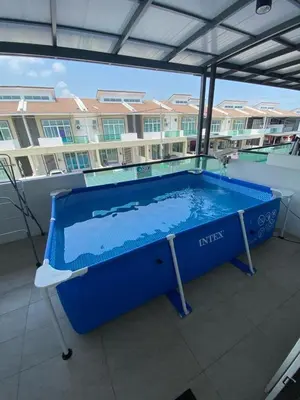 a large swimming pool on the roof of a building at Sentosa Grand Homestay in Kulim