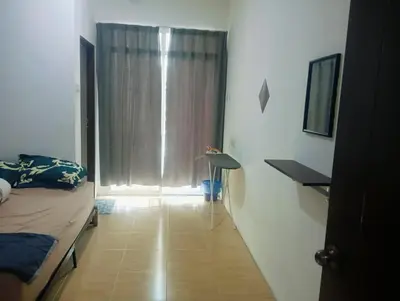a bedroom with a bed and a window with curtains at Room Stay YNS Kampar Putra 1 Bilik dan Bilik Air in Kampar