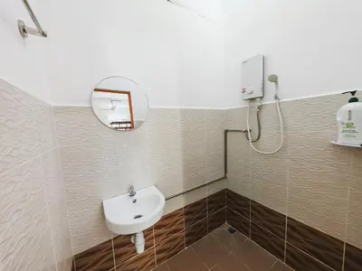 a bathroom with a sink and a mirror at Spacious 9 Rooms house 23paxQbay MallSpice Arena in Gelugor