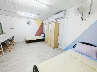 a room with a bed and a desk and a table at Spacious 9 Rooms house 23paxQbay MallSpice Arena in Gelugor