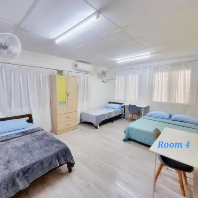 a room with two beds and a table in it at Spacious 9 Rooms house 23paxQbay MallSpice Arena in Gelugor