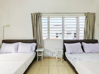 a bedroom with two beds and a window with two stools at Spacious 9 Rooms house 23paxQbay MallSpice Arena in Gelugor