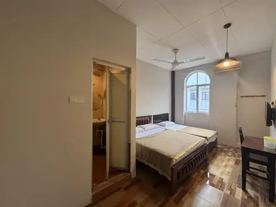 a bedroom with a bed and a window at Hotel London Kuala Lipis in Kuala Lipis