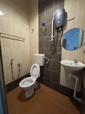 a bathroom with a toilet and a sink at Hotel London Kuala Lipis in Kuala Lipis