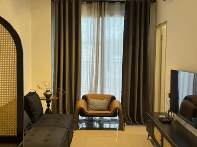 a living room with a couch and a chair in front of a window at N0ir Blanc Piccadilly Ipoh Town 3R2B 6-7pax in Ipoh