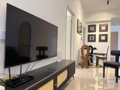 a living room with a large flat screen tv at N0ir Blanc Piccadilly Ipoh Town 3R2B 6-7pax in Ipoh