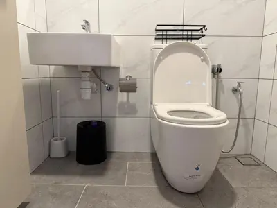 a bathroom with a white toilet and a sink at N0ir Blanc Piccadilly Ipoh Town 3R2B 6-7pax in Ipoh