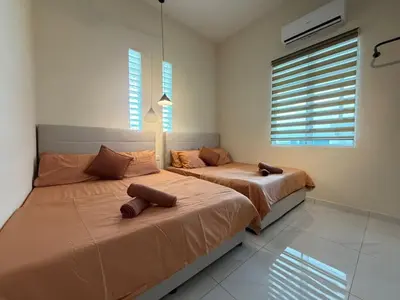 two beds in a bedroom with two windows at Rustic Vibe Pool Bungalow Karaoke 5R7B for 22pax in Ipoh