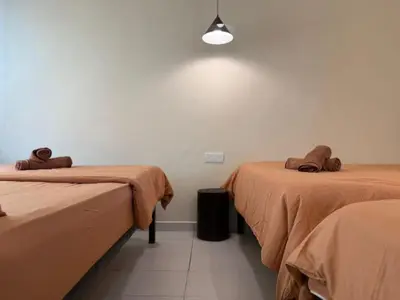 a room with two beds with brown blankets at Rustic Vibe Pool Bungalow Karaoke 5R7B for 22pax in Ipoh