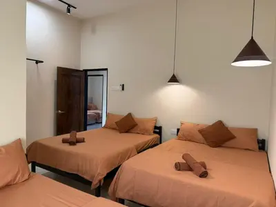 a room with two beds and a mirror at Rustic Vibe Pool Bungalow Karaoke 5R7B for 22pax in Ipoh