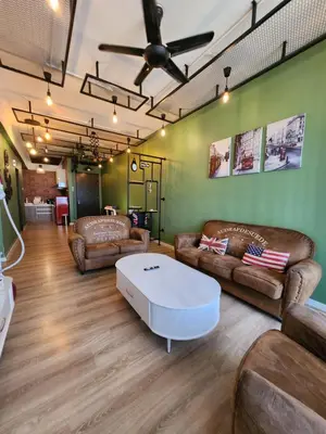 a living room with leather couches and a white coffee table at The Majestic Condo Ipoh in Ipoh