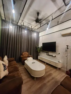a living room with a couch and a flat screen tv at The Majestic Condo Ipoh in Ipoh