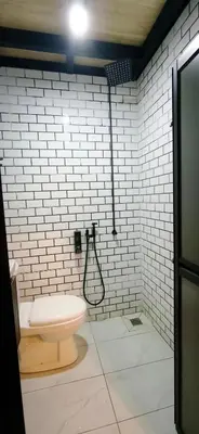 a bathroom with a toilet and a shower at Sekinchan Tiny House in Sekincan