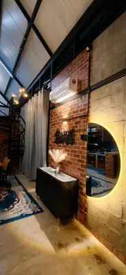 a brick wall with a table in a room at Sekinchan Tiny House in Sekincan