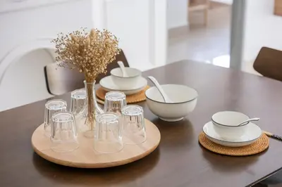 a table with glasses and bowls and a vase on it at Serene Minimalist Family Retreat 2-7pax 8 min to BoH in Brinchang