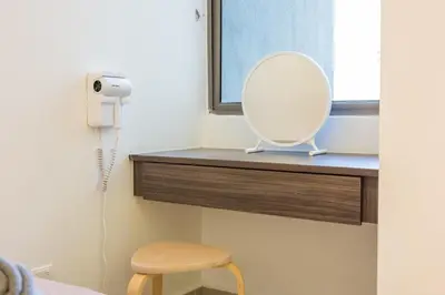 a mirror sitting on a shelf in a bedroom at Serene Minimalist Family Retreat 2-7pax 8 min to BoH in Brinchang