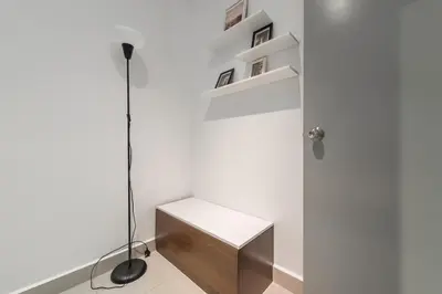 a white room with a desk and a lamp at Serene Minimalist Family Retreat 2-7pax 8 min to BoH in Brinchang