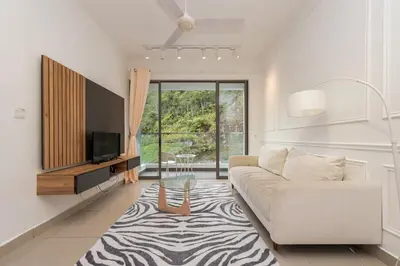 a living room with a couch and a tv at Serene Minimalist Family Retreat 2-7pax 8 min to BoH in Brinchang