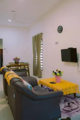 a living room with a couch and a table at Wewe Homestay CL2 in Kampung Gajah