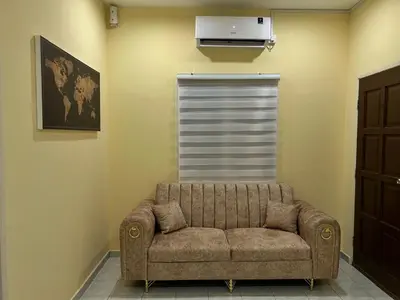 a living room with a couch in a room at Homestay D'Kampong in Teluk Intan