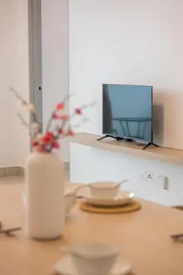 a table with a computer on top of a desk at Serene Muji Family Retreat 2-7 pax with Comfortable Living Space in Tanah Rata
