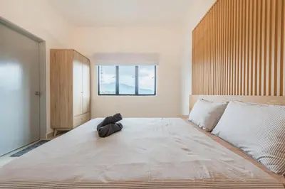 a large bed in a room with a window at Serene Muji Family Retreat 2-7 pax with Comfortable Living Space in Tanah Rata
