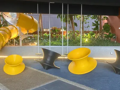 a playground with yellow chairs and a slide at The Piccadilly Greentown Residences Ipoh in Ipoh
