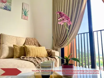 a living room with a couch and a window at The Piccadilly Greentown Residences Ipoh in Ipoh