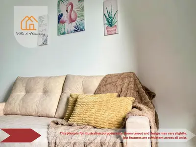 a living room with a couch with a yellow pillow at The Piccadilly Greentown Residences Ipoh in Ipoh