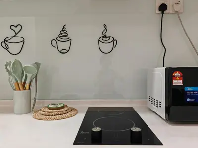 a kitchen counter with a stove and a microwave at Mansion One Studio VIP Parking Gleneagles Gurney in George Town