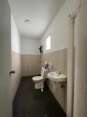 a bathroom with a toilet and a sink at Mutiara Homestay cameron in Tanah Rata