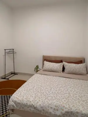 a bedroom with a large bed with pillows on it at Mutiara Homestay cameron in Tanah Rata