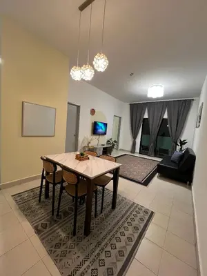 a living room with a dining room table and a couch at Mutiara Homestay cameron in Tanah Rata