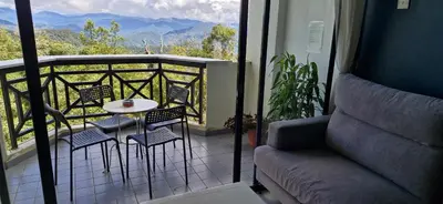 a balcony with a table and chairs and a view at A321 Silverpark Resort 1 lifted & Mountain view in Bukit Fraser