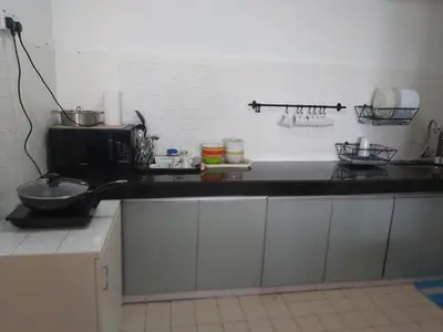 a kitchen with a black counter top and a microwave at A321 Silverpark Resort 1 lifted & Mountain view in Bukit Fraser