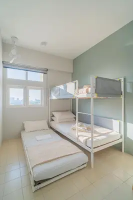 two bunk beds in a room with a window at Stylish 3BR Stay Near Gurney Drive Free Parking in George Town