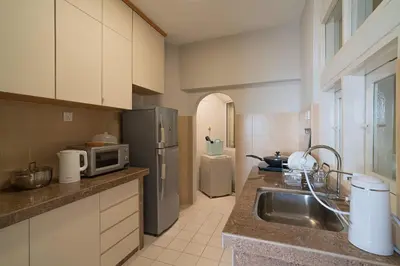 a kitchen with a sink and a microwave at Stylish 3BR Stay Near Gurney Drive Free Parking in George Town