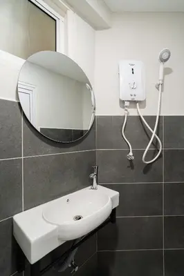 a bathroom with a sink and a mirror at Stylish 3BR Stay Near Gurney Drive Free Parking in George Town