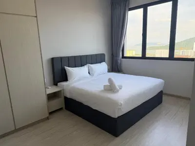 a bedroom with a bed with a large window at Homey Studio Unit Relaxing Stay at Bayan Lepas in Gua Sai