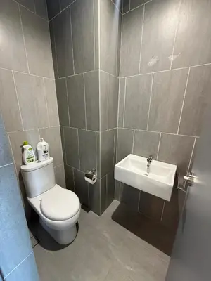 a bathroom with a toilet and a sink at Homey Studio Unit Relaxing Stay at Bayan Lepas in Gua Sai