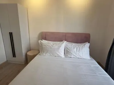 a bed with white pillows and a brown headboard at Piccadilly Residence Greentown in Ipoh