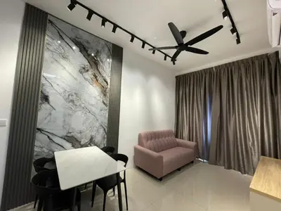 a living room with a chair and a table at Piccadilly Residence Greentown in Ipoh
