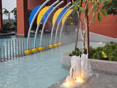 a pool with a water fountain in a building at Piccadilly Residence Greentown in Ipoh
