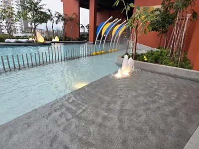 a swimming pool with a fountain in front of a building at Piccadilly Residence Greentown in Ipoh