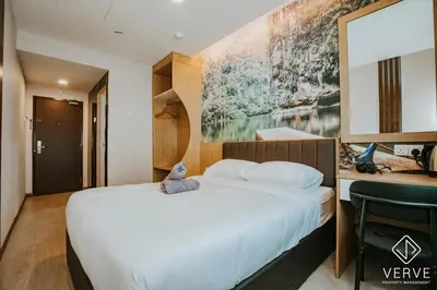 a bedroom with a bed with a stuffed animal on it at Ipoh Town Area Avs Hotel by Verve in Ipoh